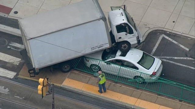 Box truck ends up on top of vehicle in crash
