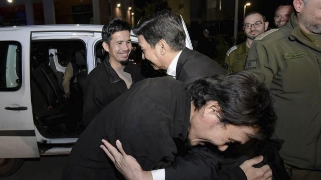 In this photo provided by Thailand's Foreign Ministry, two newly-freed Thai hostages hug Thai Foreign Minister Parnpree Bahiddha-Nukara, center, at the Shamir Medical Center in Israel, Tuesday, Nov. 28, 2023. Hamas freed several Thai nationals seized in the group's surprise attack on southern Israel the month before, releasing them alongside Israeli hostages under a cease-fire deal. (Thailand's Foreign Ministry via AP )