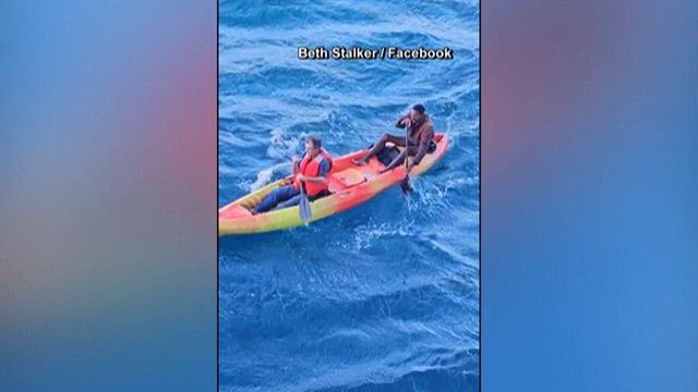 Cruise ship crew members help 2 men on board kayak after their boat sank