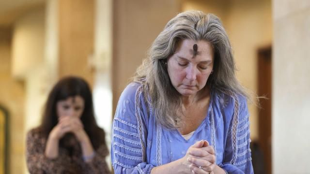 FILE - Dorsey Prince, right, and Shannon Carter pray during an Ash Wednesday Mass at St. John Neumann Catholic Church in Austin, Texas, Feb. 22, 2023. In 2024, Feb. 14 is a holiday heavyweight due to a calendar collision of events — it’s Valentine’s Day and Ash Wednesday. (Jay Janner/Austin American-Statesman via AP, File) FILE - Dorsey Prince, right, and Shannon Carter pray during an Ash Wednesday Mass at St. John Neumann Catholic Church in Austin, Texas, Feb. 22, 2023. In 2024, Feb. 14 is a holiday heavyweight due to a calendar collision of events — it’s Valentine’s Day and Ash Wednesday. (Jay Janner/Austin American-Statesman via AP, File)