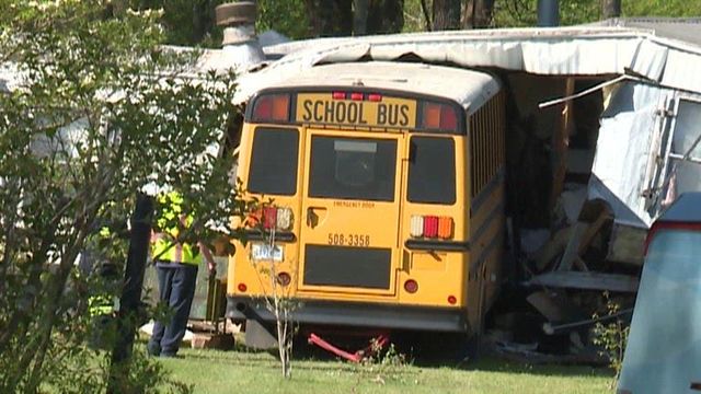 School bus crashes into mobile home
