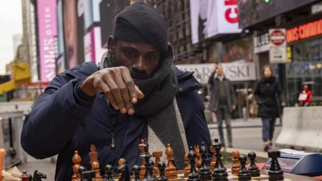 Tunde Onakoya, 29, a Nigerian chess champion and child education advocate, plays a chess game in Times Square, Friday, April 19, 2024 in New York. (AP Photo/Yuki Iwamura)
