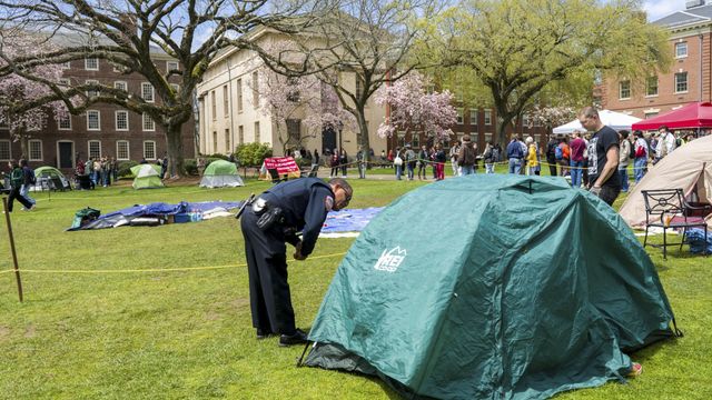 Campus police check student IDs at a pro-Palestinian encampment at Brown University in Providence, R.I., on Wednesday, April 24, 2024. There were nearly two dozen new arrests, mostly in Texas, as universities moved to prevent pro-Palestinian encampments from taking hold as they have at Columbia University. (Philip Keith/The New York Times)