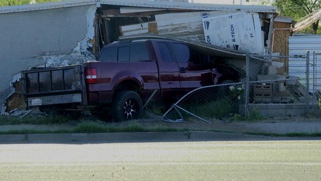 Truck plows into house