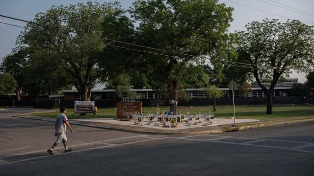 A memorial honoring the 21 victims killed in the Robb Elementary School shooting in 2022 stands outside of the school in Uvalde, Texas, May 22, 2024. The families of schoolchildren who were shot at Robb Elementary School in 2022 filed two lawsuits on Friday accusing Instagram, the publisher of the popular “Call of Duty” video game and a manufacturer of semiautomatic rifles of helping to train and equip the teenage gunman who committed the massacre. (Tamir Kalifa/The New York Times)