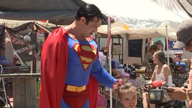 Superman poses with a young fan at a Superman celebration in Metropolis, Illinois.