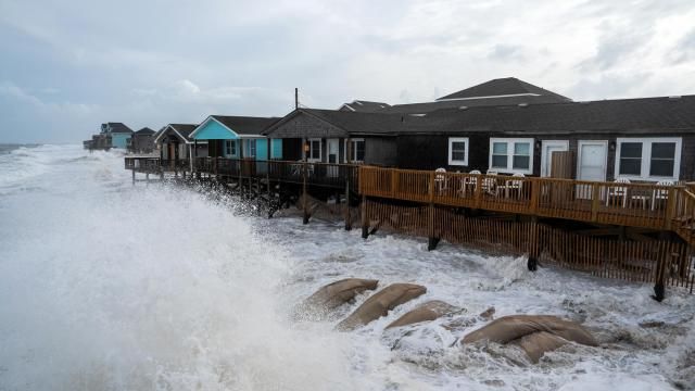 Waves driven by Hurricane Erin crash over sandags placed on the beach in Buxton, N.C., near Cape Hatteras, on Wednesday evening, Aug. 20, 2025. Erin is “unusually large” and ranks among the largest hurricanes ever in the Atlantic, the National Hurricane Center said on Wednesday. (Daniel Pullen/The New York Times)
