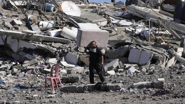 Palestinians visit their houses destroyed in the Israeli bombings in Al-Zahra, on the outskirts of Gaza City, on Thursday, Nov. 30, 2023. during the temporary ceasefire between Hamas and Israel. (AP Photo/Adel Hana)