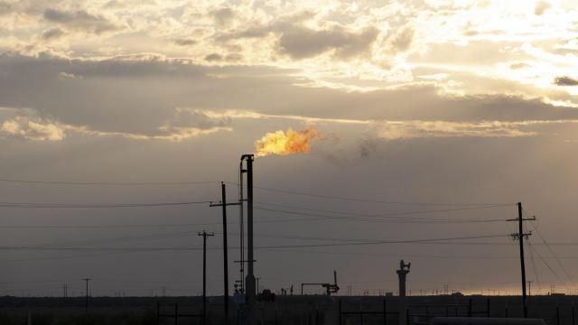 FILE — A gas flare in the Permian Basin, in Pecos, Texas, on Oct. 8, 2019. In the short term, methane is about 80 times more potent than carbon dioxide. (Jessica Lutz/The New York Times)