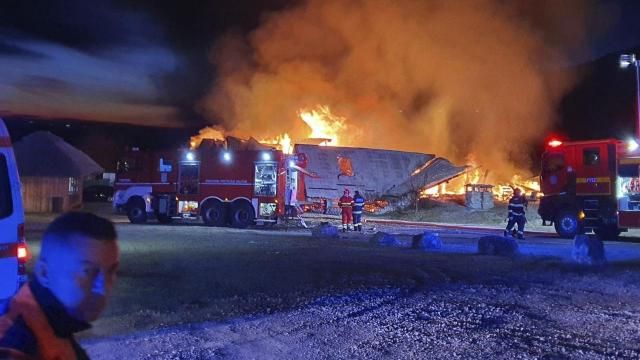 In this photo released by the Romanian Emergency Services Prahova (ISU Prahova), a guesthouse is burning in Tohani, Romania, Tuesday, Dec. 26, 2023. A huge fire at a guesthouse in Romania on Tuesday morning has left several people dead, including a child, and some people are missing, authorities said. (Romanian Emergency Services - ISU Prahova via AP)