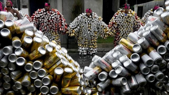 Revelers wearing costumes made from beer and soda cans prepare to take part in the 'Bloco da Latinha' street party Carnival parade in Madre de Deus, Brazil, Sunday, Feb. 11, 2024. (AP Photo/Eraldo Peres) Revelers wearing costumes made from beer and soda cans prepare to take part in the 'Bloco da Latinha' street party Carnival parade in Madre de Deus, Brazil, Sunday, Feb. 11, 2024. (AP Photo/Eraldo Peres)