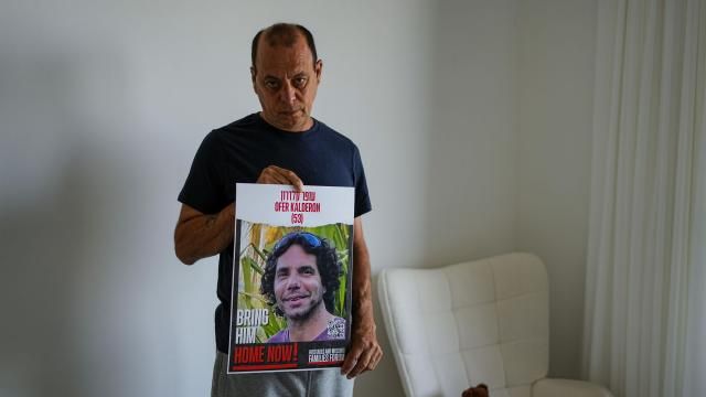Nissan Kalderon poses with a photo of his only brother, Ofer, a hostage held in the Gaza Strip by the Hamas militant group, in Ramat Gan, Israel, Wednesday, March 13, 2024. With each passing day, the relatives of hostages in Gaza face a deepening despair. (AP Photo/Ariel Schalit) Nissan Kalderon poses with a photo of his only brother, Ofer, a hostage held in the Gaza Strip by the Hamas militant group, in Ramat Gan, Israel, Wednesday, March 13, 2024. With each passing day, the relatives of hostages in Gaza face a deepening despair. (AP Photo/Ariel Schalit)