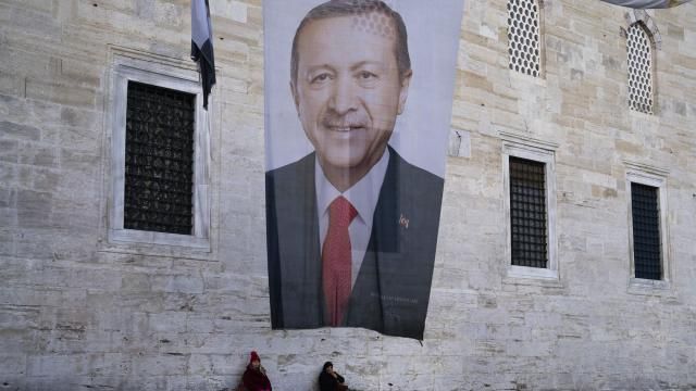 Two women sit near a campaign banner of Turkish President and leader of the Justice and Development Party, or AKP, Recep Tayyip in Istanbul, Turkey, Monday, March 11, 2024. Turkey was coming to terms on Monday with the opposition's unexpected success in local elections which saw it outperform President Recep Tayyip Erdogan's ruling party and add to municipalities gained five years ago. (AP Photo/Francisco Seco) Two women sit near a campaign banner of Turkish President and leader of the Justice and Development Party, or AKP, Recep Tayyip in Istanbul, Turkey, Monday, March 11, 2024. Turkey was coming to terms on Monday with the opposition's unexpected success in local elections which saw it outperform President Recep Tayyip Erdogan's ruling party and add to municipalities gained five years ago. (AP Photo/Francisco Seco)