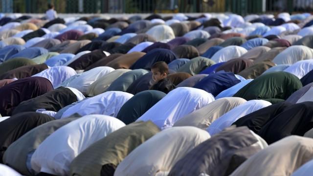 A Muslim child stands beside his father performing an Eid al-Fitr prayer with others, marking the end of the fasting month of Ramadan, in Rawalpindi, Pakistan, Wednesday, April, 10, 2024. (AP Photo/Anjum Naveed) A Muslim child stands beside his father performing an Eid al-Fitr prayer with others, marking the end of the fasting month of Ramadan, in Rawalpindi, Pakistan, Wednesday, April, 10, 2024. (AP Photo/Anjum Naveed)