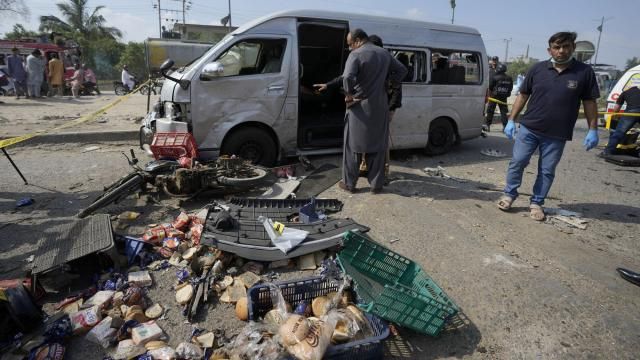 CORRECTS DATE - Pakistani investigators examine a damaged van at the site of a suicide attack in Karachi, Pakistan, Friday, April 19, 2024. Five Japanese nationals traveling in a van narrowly escaped a suicide attack when a suicide bomber detonated his explosive-laden vest near their vehicle in Pakistan's port city of Karachi on Friday, wounding three passers-by, police said. (AP Photo/Fareed Khan) CORRECTS DATE - Pakistani investigators examine a damaged van at the site of a suicide attack in Karachi, Pakistan, Friday, April 19, 2024. Five Japanese nationals traveling in a van narrowly escaped a suicide attack when a suicide bomber detonated his explosive-laden vest near their vehicle in Pakistan's port city of Karachi on Friday, wounding three passers-by, police said. (AP Photo/Fareed Khan)
