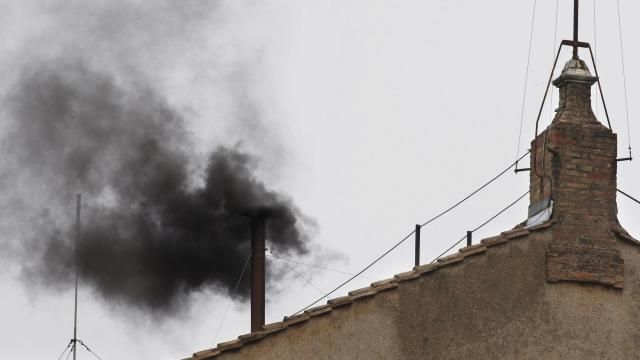 FILE - Black smoke emerges from the chimney on the Sistine Chapel as cardinals voted on the second day of the conclave to elect a pope in St. Peter's Square at the Vatican, Wednesday, March 13, 2013. (AP Photo/Michael Sohn, File)