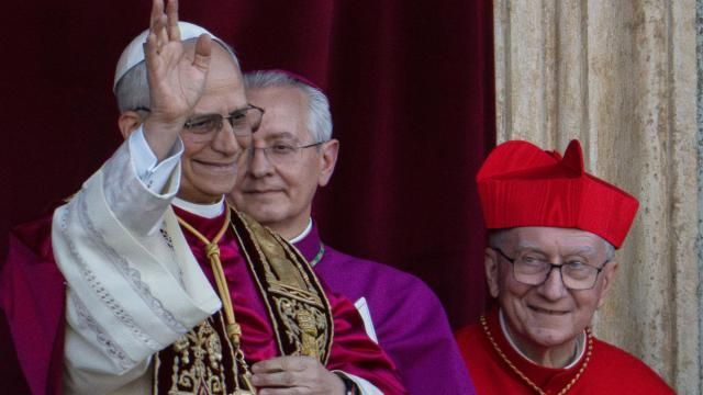 Newly elected Pope Leo XIV, left, formerly Cardinal Robert Francis Prevost, appears with, from left, Master of Ceremonies Archbishop Diego Giovanni Ravelli, and former Vatican Secretary of State Cardinal Pietro Parolin on the central loggia of St. Peter's Basilica at the Vatican shortly after his election as the 267th pontiff of the Roman Catholic Church, Thursday, May 8, 2025. (AP Photo/Domenico Stinellis)