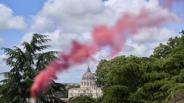 FILE - Pink smoke rises in front of St. Peter's Basilica during a protest by the Women's Ordination Conference calling for full equality for women in the Catholic Church on the first day of the conclave to elect the 267th pope in Rome on Wednesday, May 7, 2025. (AP Photo/Bernat Armangue, File)