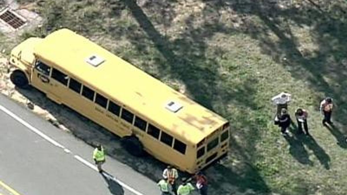 Truck overturns after hitting school bus