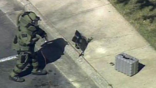 Raw video: Bomb squad member inspects package