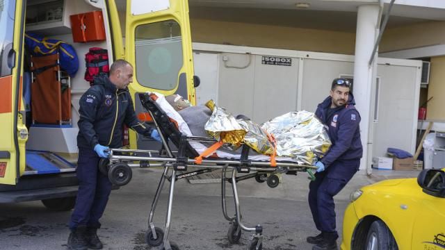 Paramedics transfer a survivor of a shipwreck at a hospital, on the northeastern Aegean Sea island of Lesbos, Greece, Sunday, Nov. 26, 2023. A cargo ship sank off the Greek island of Lesbos early Sunday, leaving 13 crew members missing and one rescued, authorities said. The Raptor, registered in the Comoros, was on its way to Istanbul from Alexandria, Egypt, carrying 6,000 tons of salt, the coast guard said. It had a crew of 14, including eight Egyptians, four Indians and two Syrians, the coast guard said.(AP Photo/Panagiotis Balaskas)