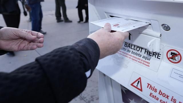 FILE - A voter places a ballot in a drop box outside the Denver Elections Division headquarters Nov. 8, 2022, in downtown Denver. The nation's cybersecurity agency is launching a program aimed at boosting election security in the states, shoring up support for local offices and hoping to provide reassurance to voters that this year's presidential elections will be safe and accurate. (AP Photo/David Zalubowski, File) FILE - A voter places a ballot in a drop box outside the Denver Elections Division headquarters Nov. 8, 2022, in downtown Denver. The nation's cybersecurity agency is launching a program aimed at boosting election security in the states, shoring up support for local offices and hoping to provide reassurance to voters that this year's presidential elections will be safe and accurate. (AP Photo/David Zalubowski, File)