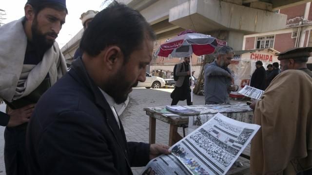 People read morning newspaper reporting the early results of parliamentary elections at a stall in Peshawar, Pakistan, Friday, Feb. 9, 2024. The results of Pakistan's elections were delayed a day after the vote that was marred by sporadic violence, a mobile phone service shutdown and the sidelining of former Prime Minister Imran Khan and his party. (AP Photo/Muhammad Sajjad) People read morning newspaper reporting the early results of parliamentary elections at a stall in Peshawar, Pakistan, Friday, Feb. 9, 2024. The results of Pakistan's elections were delayed a day after the vote that was marred by sporadic violence, a mobile phone service shutdown and the sidelining of former Prime Minister Imran Khan and his party. (AP Photo/Muhammad Sajjad)