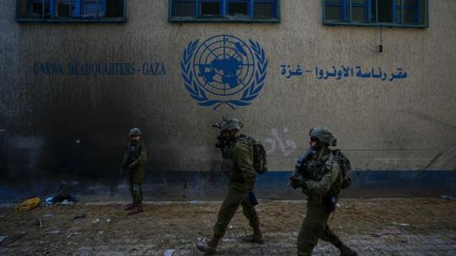 Israeli soldiers take position as they enter the UNRWA headquarter where the military discovered tunnels underneath of the U.N. agency that the military says Hamas militants used to attack its forces during a ground operation in Gaza, Thursday, Feb. 8, 2024. The Israeli military says it has discovered tunnels underneath the main headquarters of the U.N. agency for Palestinian refugees in Gaza City, alleging that Hamas militants used the space as an electrical supply room. The unveiling of the tunnels marked the latest chapter in Israel's campaign against the embattled agency, which it accuses of collaborating with Hamas. (AP Photo/Ariel Schalit) Israeli soldiers take position as they enter the UNRWA headquarter where the military discovered tunnels underneath of the U.N. agency that the military says Hamas militants used to attack its forces during a ground operation in Gaza, Thursday, Feb. 8, 2024. The Israeli military says it has discovered tunnels underneath the main headquarters of the U.N. agency for Palestinian refugees in Gaza City, alleging that Hamas militants used the space as an electrical supply room. The unveiling of the tunnels marked the latest chapter in Israel's campaign against the embattled agency, which it accuses of collaborating with Hamas. (AP Photo/Ariel Schalit)