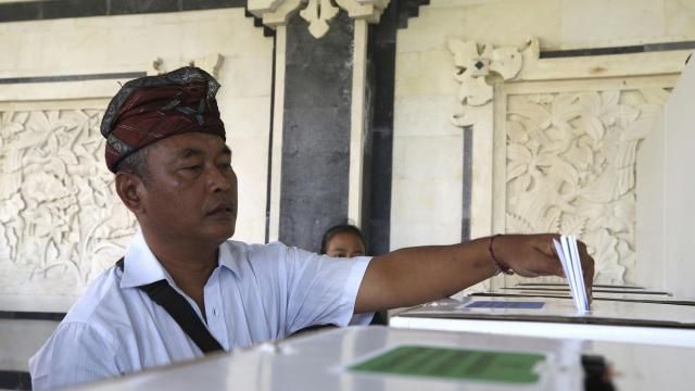 A man casts his ballot at a polling station during the presidential and legislative election in Denpasar, Bali, Indonesia, on Wednesday, Feb. 14, 2024. (AP Photo/Firdia Lisnawati) A man casts his ballot at a polling station during the presidential and legislative election in Denpasar, Bali, Indonesia, on Wednesday, Feb. 14, 2024. (AP Photo/Firdia Lisnawati)