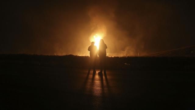 Two men look at flames after a natural gas pipeline explodes outside the city of Boroujen in the western Chaharmahal and Bakhtiari province, Iran, in early Wednesday, Feb. 14, 2024. Explosions struck a natural gas pipeline in Iran early Wednesday, with an official blaming the blasts on a "sabotage and terrorist action" in the country as tensions remain high in the Middle East amid Israel's war on Hamas in the Gaza Strip. (Reza Kamali Dehkordi/Fars News Agency via AP) Two men look at flames after a natural gas pipeline explodes outside the city of Boroujen in the western Chaharmahal and Bakhtiari province, Iran, in early Wednesday, Feb. 14, 2024. Explosions struck a natural gas pipeline in Iran early Wednesday, with an official blaming the blasts on a "sabotage and terrorist action" in the country as tensions remain high in the Middle East amid Israel's war on Hamas in the Gaza Strip. (Reza Kamali Dehkordi/Fars News Agency via AP)