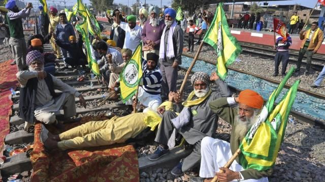 Protesting farmers demanding guaranteed crop prices for their produce sit on train tracks at a railway station in Rajpura, India, Thursday, Feb.15, 2024. Some farmer and trade unions have announced a countrywide rural strike on Friday. (AP Photo/Rajesh Sachar) Protesting farmers demanding guaranteed crop prices for their produce sit on train tracks at a railway station in Rajpura, India, Thursday, Feb.15, 2024. Some farmer and trade unions have announced a countrywide rural strike on Friday. (AP Photo/Rajesh Sachar)