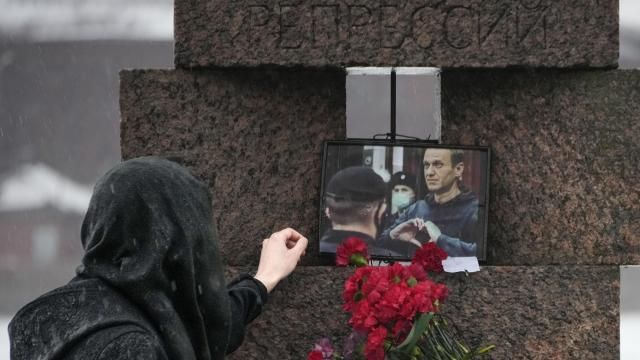 A woman touches a photo of Alexei Navalny after laying flowers paying the last respect to him at the Memorial to Victims of Political Repression in St. Petersburg, Russia on Saturday, Feb. 17, 2024. Russian authorities say that Alexei Navalny, the fiercest foe of Russian President Vladimir Putin who crusaded against official corruption and staged massive anti-Kremlin protests, died in prison. He was 47. (AP Photo/Dmitri Lovetsky) A woman touches a photo of Alexei Navalny after laying flowers paying the last respect to him at the Memorial to Victims of Political Repression in St. Petersburg, Russia on Saturday, Feb. 17, 2024. Russian authorities say that Alexei Navalny, the fiercest foe of Russian President Vladimir Putin who crusaded against official corruption and staged massive anti-Kremlin protests, died in prison. He was 47. (AP Photo/Dmitri Lovetsky)
