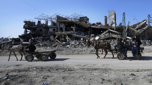 Palestinians ride on donkey carts through destruction from the Israeli bombardment at the main road of Salah el Dein in the Maghazi refugee camp, central Gaza Strip, Friday, Feb. 16, 2024. (AP Photo/Adel Hana) Palestinians ride on donkey carts through destruction from the Israeli bombardment at the main road of Salah el Dein in the Maghazi refugee camp, central Gaza Strip, Friday, Feb. 16, 2024. (AP Photo/Adel Hana)