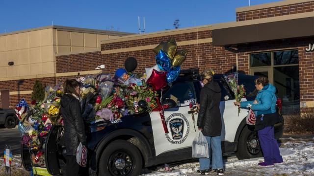 Three individuals holding flowers approach one of three memorials outside the Burnsville Police Department and City Hall building in Burnsville, Minn., on Tuesday, Feb. 20, 2024. Two police officers and a firefighter who responded to a domestic situation at a suburban Minneapolis home were killed early Sunday. (Kerem Yücel /Minnesota Public Radio via AP) Three individuals holding flowers approach one of three memorials outside the Burnsville Police Department and City Hall building in Burnsville, Minn., on Tuesday, Feb. 20, 2024. Two police officers and a firefighter who responded to a domestic situation at a suburban Minneapolis home were killed early Sunday. (Kerem Yücel /Minnesota Public Radio via AP)