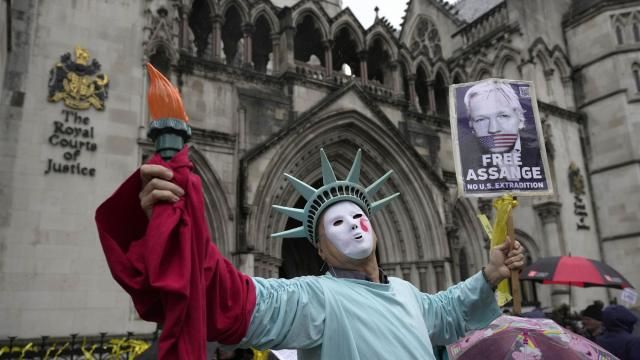 A protester stands outside the Royal Courts of Justice in London, Wednesday, Feb. 21, 2024. Julian Assange's lawyers are on their final U.K. legal challenge to stop the WikiLeaks founder from being sent to the United States to face spying charges. The 52-year-old has been fighting extradition for more than a decade, including seven years in self-exile in the Ecuadorian Embassy in London and the last five years in a high-security prison. (AP Photo/Kin Cheung) A protester stands outside the Royal Courts of Justice in London, Wednesday, Feb. 21, 2024. Julian Assange's lawyers are on their final U.K. legal challenge to stop the WikiLeaks founder from being sent to the United States to face spying charges. The 52-year-old has been fighting extradition for more than a decade, including seven years in self-exile in the Ecuadorian Embassy in London and the last five years in a high-security prison. (AP Photo/Kin Cheung)