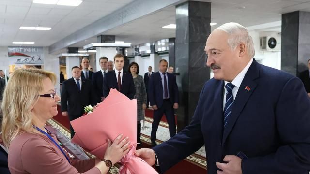 In this photo provided by the Belarusian Presidential Press Service, Belarus President Alexander Lukashenko, right, presents flowers to an election commission official ahead of voting at a polling station, in Minsk, Belarus, Sunday, Feb. 25, 2024. Lukashenko was believed a few years ago to be considering whether to lead the new body after stepping down, but his calculus has apparently changed, and he announced on Sunday that he will run in next year's presidential election. (Belarusian Presidential Press Service via AP) In this photo provided by the Belarusian Presidential Press Service, Belarus President Alexander Lukashenko, right, presents flowers to an election commission official ahead of voting at a polling station, in Minsk, Belarus, Sunday, Feb. 25, 2024. Lukashenko was believed a few years ago to be considering whether to lead the new body after stepping down, but his calculus has apparently changed, and he announced on Sunday that he will run in next year's presidential election. (Belarusian Presidential Press Service via AP)