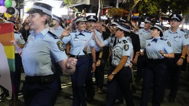 The New South Wales Police Commissioner Karen Webb, second left, waves as she marches in the 45th Anniversary Sydney Gay and Lesbian Mardi Gras Parade in Oxford Street, Sydney, Australia, Saturday, Feb. 25, 2023. Organizers of the Sydney Gay and Lesbian Mardi Gras have asked police not to march at their annual parade at the weekend due to an alleged murder of a couple by a police officer, prompting the police commissioner on Tuesday, Feb, 27, 2024, to urge the ban be reversed. (AP Photo/Mark Baker) The New South Wales Police Commissioner Karen Webb, second left, waves as she marches in the 45th Anniversary Sydney Gay and Lesbian Mardi Gras Parade in Oxford Street, Sydney, Australia, Saturday, Feb. 25, 2023. Organizers of the Sydney Gay and Lesbian Mardi Gras have asked police not to march at their annual parade at the weekend due to an alleged murder of a couple by a police officer, prompting the police commissioner on Tuesday, Feb, 27, 2024, to urge the ban be reversed. (AP Photo/Mark Baker)