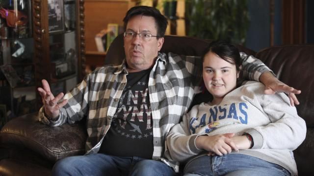Rick Elskamp sits with his oldest daughter, Sheridan, and discusses the frustrations of having his 23-year-old daughter on a waiting list for 10 years for services as an intellectually disabled adult, Saturday, Jan. 27, 2024, at the Elskamps' home outside Topeka, Kan. Thousands of Kansas residents with disabilities and hundreds of thousands across the U.S. are on waiting lists for services. (AP Photo/John Hanna) Rick Elskamp sits with his oldest daughter, Sheridan, and discusses the frustrations of having his 23-year-old daughter on a waiting list for 10 years for services as an intellectually disabled adult, Saturday, Jan. 27, 2024, at the Elskamps' home outside Topeka, Kan. Thousands of Kansas residents with disabilities and hundreds of thousands across the U.S. are on waiting lists for services. (AP Photo/John Hanna)