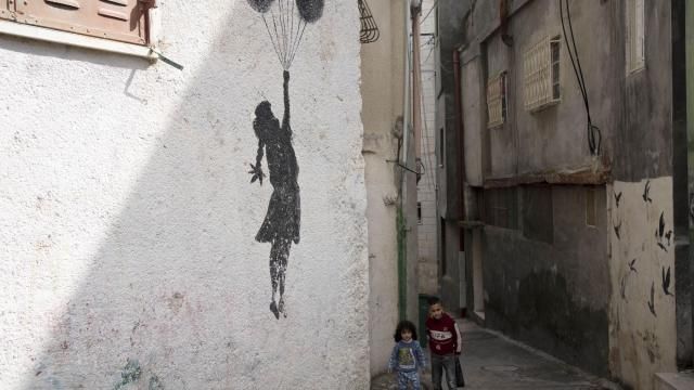 Palestinian children walk in an alley of the Aida Refugee Camp, near the health clinic and school run by the the United Nations Relief and Works Agency for Palestinian Refugees in the Near East (UNRWA) in the West Bank city of Bethlehem, Tuesday, Feb. 20, 2024. (AP Photo/Maya Alleruzzo) Palestinian children walk in an alley of the Aida Refugee Camp, near the health clinic and school run by the the United Nations Relief and Works Agency for Palestinian Refugees in the Near East (UNRWA) in the West Bank city of Bethlehem, Tuesday, Feb. 20, 2024. (AP Photo/Maya Alleruzzo)