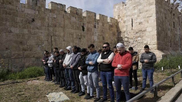 Palestinian Muslims pray outside of the walls of the Old City of Jerusalem after Israeli police denied their entry to the Al-Aqsa Mosque compound for Friday prayers, Friday, March 1, 2024. (AP Photo/Mahmoud Illean) Palestinian Muslims pray outside of the walls of the Old City of Jerusalem after Israeli police denied their entry to the Al-Aqsa Mosque compound for Friday prayers, Friday, March 1, 2024. (AP Photo/Mahmoud Illean)