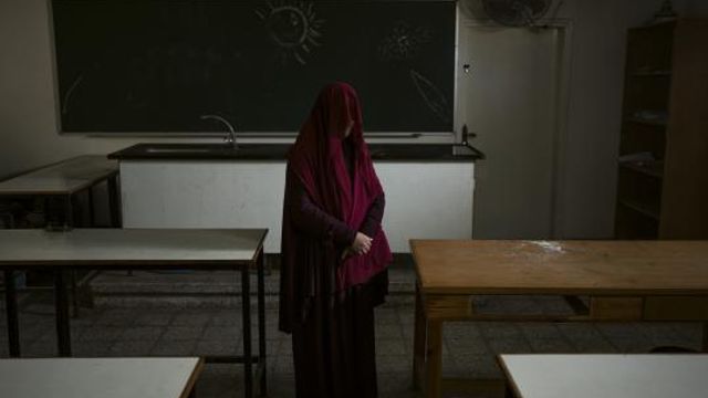 Nabela, who was detained by Israeli forces, poses for a portrait at the U.N. school where she is sheltering in Rafah, southern Gaza Strip, Friday, Feb. 23, 2024. Like many Palestinians in Gaza, Nabela thought she had found a safe place to shelter in a U.N. school. Then, the Israeli army arrived. She says soldiers stormed the school, ordering men to strip to their underwear and hauling women to a nearby mosque for strip searches. So began six harrowing weeks in Israeli custody that she says included repeated beatings and interrogations. (AP Photo/Fatima Shbair) Nabela, who was detained by Israeli forces, poses for a portrait at the U.N. school where she is sheltering in Rafah, southern Gaza Strip, Friday, Feb. 23, 2024. Like many Palestinians in Gaza, Nabela thought she had found a safe place to shelter in a U.N. school. Then, the Israeli army arrived. She says soldiers stormed the school, ordering men to strip to their underwear and hauling women to a nearby mosque for strip searches. So began six harrowing weeks in Israeli custody that she says included repeated beatings and interrogations. (AP Photo/Fatima Shbair)