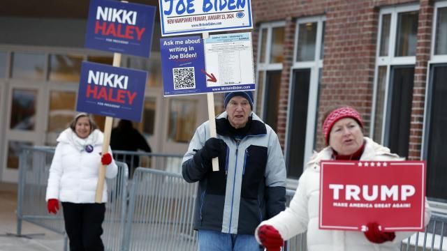 FILE - Candidate supporters stand outside a polling location in the presidential primary election, Jan. 23, 2024, in Windham, N.H. Super Tuesday is feeling anything but for many Americans, with the leading presidential contenders already appearing set. A primary season that engages only a fraction of the electorate to choose the presidential candidates is a reminder of how the U.S. election system excludes many voters and differs starkly from that of most other democracies around the world. (AP Photo/Michael Dwyer, File) FILE - Candidate supporters stand outside a polling location in the presidential primary election, Jan. 23, 2024, in Windham, N.H. Super Tuesday is feeling anything but for many Americans, with the leading presidential contenders already appearing set. A primary season that engages only a fraction of the electorate to choose the presidential candidates is a reminder of how the U.S. election system excludes many voters and differs starkly from that of most other democracies around the world. (AP Photo/Michael Dwyer, File)