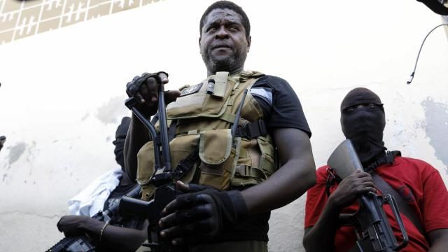 Barbecue, the leader of the "G9 and Family" gang, stands with his fellow gang members after speaking to journalists in the Delmas 6 neighborhood of Port-au-Prince in Port-au-Prince, Haiti, Tuesday, March 5, 2024. Haiti's latest violence began with a direct challenge from the former elite police officer Jimmy Chérizier, known as Barbecue, who said he would target government ministers to prevent the prime minister's return and force his resignation. (AP Photo/Odelyn Joseph) Barbecue, the leader of the "G9 and Family" gang, stands with his fellow gang members after speaking to journalists in the Delmas 6 neighborhood of Port-au-Prince in Port-au-Prince, Haiti, Tuesday, March 5, 2024. Haiti's latest violence began with a direct challenge from the former elite police officer Jimmy Chérizier, known as Barbecue, who said he would target government ministers to prevent the prime minister's return and force his resignation. (AP Photo/Odelyn Joseph)