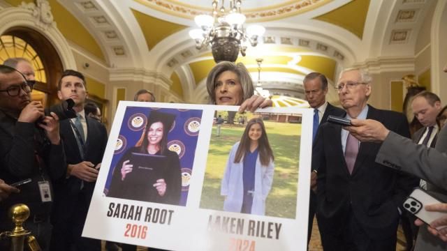 FILE - Sen. Joni Ernst, R-Iowa, holds a poster with photos of murder victims Sarah Root and Laken Riley as she speaks on Capitol Hill, Feb. 27, 2024, in Washington. House Republicans have passed a bill that would require federal authorities to detain unauthorized immigrants who have been accused of theft, seizing on the recent death of Laken, a nursing student in Georgia. The bill sends a rebuke to President Joe Biden’s border policies just hours ahead of his State of the Union address. However, the nine-page bill had little chance of being taken up in the Democratic-controlled Senate. (AP Photo/Mark Schiefelbein, File) FILE - Sen. Joni Ernst, R-Iowa, holds a poster with photos of murder victims Sarah Root and Laken Riley as she speaks on Capitol Hill, Feb. 27, 2024, in Washington. House Republicans have passed a bill that would require federal authorities to detain unauthorized immigrants who have been accused of theft, seizing on the recent death of Laken, a nursing student in Georgia. The bill sends a rebuke to President Joe Biden’s border policies just hours ahead of his State of the Union address. However, the nine-page bill had little chance of being taken up in the Democratic-controlled Senate. (AP Photo/Mark Schiefelbein, File)