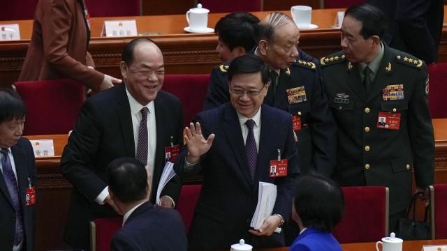 Hong Kong Chief Executive John Lee, center, waves to delegates after the opening session of the National People's Congress (NPC) at the Great Hall of the People in Beijing, Tuesday, March 5, 2024. (AP Photo/Andy Wong) Hong Kong Chief Executive John Lee, center, waves to delegates after the opening session of the National People's Congress (NPC) at the Great Hall of the People in Beijing, Tuesday, March 5, 2024. (AP Photo/Andy Wong)