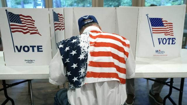 FILE - A patriotic voter sits at a voting kiosk and selects his choices in a party primary in Jackson, Miss., Tuesday, Aug. 8, 2023. Super Tuesday put former President Donald Trump within reach of clinching his third consecutive Republican presidential nomination. But it may be Republican voters in Georgia, Hawaii, Mississippi and Washington who put him over the top. President Joe Biden is also competing in presidential contests that day, but the earliest he can clinch his party's nomination is a week later on March 19. (AP Photo/Rogelio V. Solis, File) FILE - A patriotic voter sits at a voting kiosk and selects his choices in a party primary in Jackson, Miss., Tuesday, Aug. 8, 2023. Super Tuesday put former President Donald Trump within reach of clinching his third consecutive Republican presidential nomination. But it may be Republican voters in Georgia, Hawaii, Mississippi and Washington who put him over the top. President Joe Biden is also competing in presidential contests that day, but the earliest he can clinch his party's nomination is a week later on March 19. (AP Photo/Rogelio V. Solis, File)