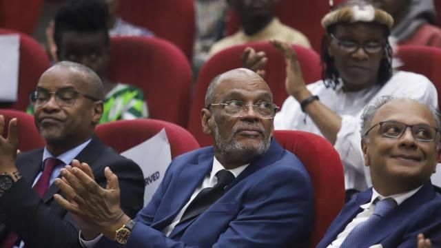 FILE - Haiti's Prime Minister Ariel Henry attends a public lecture at the United States International University in Nairobi, Kenya, March 1, 2024. The prime minister had traveled to Kenya to push for the U.N.-backed deployment of a police force from the East African country to fight gangs in Haiti. Henry, who is facing calls to resign or form a transitional council, remains unable to return home. (AP Photo/Andrew Kasuku, File) FILE - Haiti's Prime Minister Ariel Henry attends a public lecture at the United States International University in Nairobi, Kenya, March 1, 2024. The prime minister had traveled to Kenya to push for the U.N.-backed deployment of a police force from the East African country to fight gangs in Haiti. Henry, who is facing calls to resign or form a transitional council, remains unable to return home. (AP Photo/Andrew Kasuku, File)