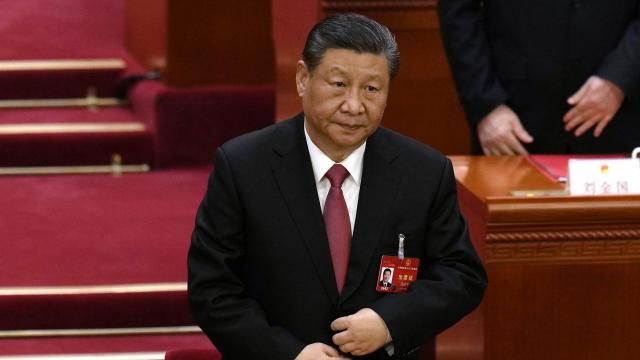 Chinese President Xi Jinping adjusts his jacket as he stands to sing the national anthem at the closing session of the National People's Congress held at the Great Hall of the People in Beijing, Monday, March 11, 2024. (AP Photo/Ng Han Guan) Chinese President Xi Jinping adjusts his jacket as he stands to sing the national anthem at the closing session of the National People's Congress held at the Great Hall of the People in Beijing, Monday, March 11, 2024. (AP Photo/Ng Han Guan)