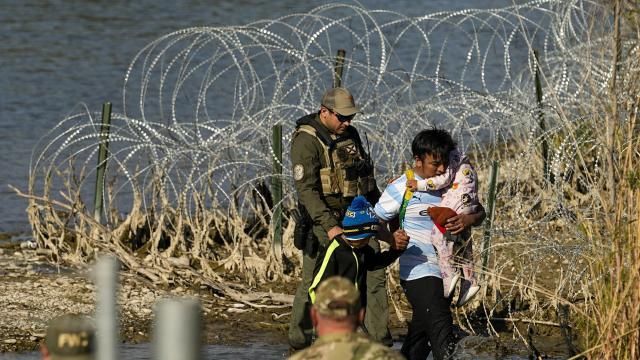 FILE - Migrants are taken into custody by officials at the Texas-Mexico border, Jan. 3, 2024, in Eagle Pass, Texas. The Supreme Court on Tuesday, March 12, 2024 extended a stay on a new Texas law that would empower police to arrest migrants suspected of illegally crossing the U.S.-Mexico border. The order puts the law on hold until at least Monday while the high court considers a challenge by the Justice Department, which has called the law an unconstitutional overreach. (AP Photo/Eric Gay, file) FILE - Migrants are taken into custody by officials at the Texas-Mexico border, Jan. 3, 2024, in Eagle Pass, Texas. The Supreme Court on Tuesday, March 12, 2024 extended a stay on a new Texas law that would empower police to arrest migrants suspected of illegally crossing the U.S.-Mexico border. The order puts the law on hold until at least Monday while the high court considers a challenge by the Justice Department, which has called the law an unconstitutional overreach. (AP Photo/Eric Gay, file)