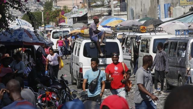 Pedestrians and commuters fill a street in Port-au-Prince, Haiti, Tuesday, March 12, 2024. Haitian Prime Minister Ariel Henry announced Tuesday that he would resign once a transitional presidential council is created, bowing to international pressure to make way for new leadership in the country overwhelmed by violent gangs. (AP Photo/Odelyn Joseph) Pedestrians and commuters fill a street in Port-au-Prince, Haiti, Tuesday, March 12, 2024. Haitian Prime Minister Ariel Henry announced Tuesday that he would resign once a transitional presidential council is created, bowing to international pressure to make way for new leadership in the country overwhelmed by violent gangs. (AP Photo/Odelyn Joseph)